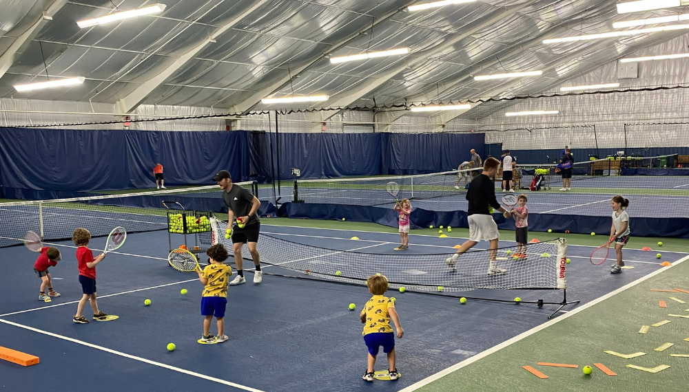 tennis instructor and child